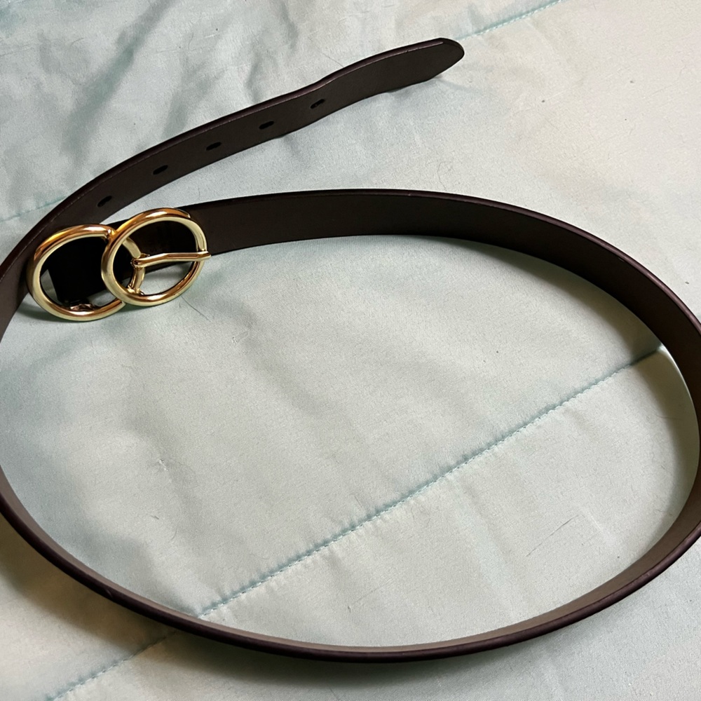 Black leather belt with gold clasp.